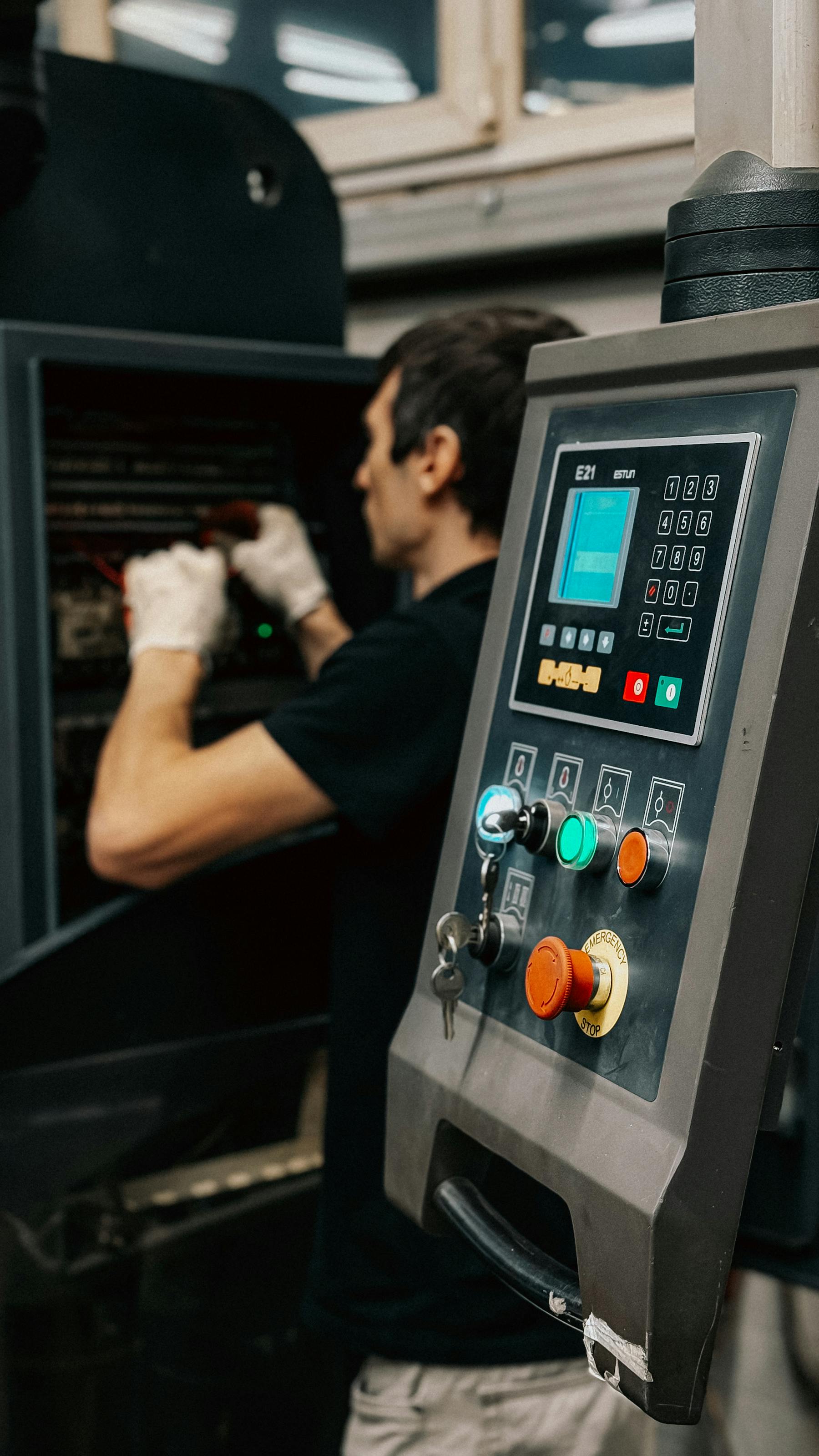 Technician checking PLC control cabinet